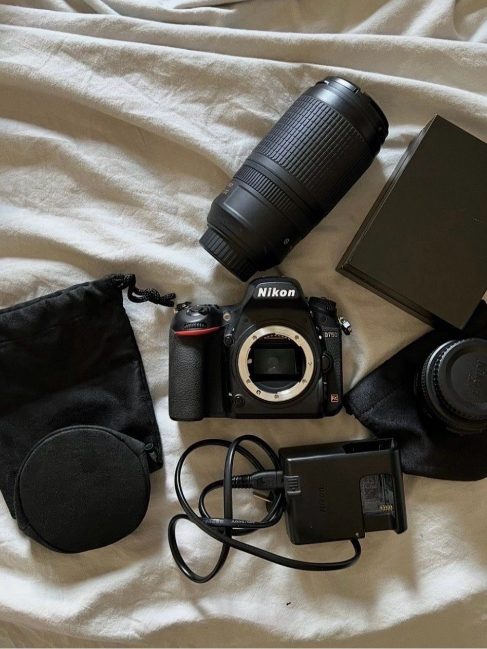 Nikon DSLR Camera Body with Black Telephoto Lens and Accessories